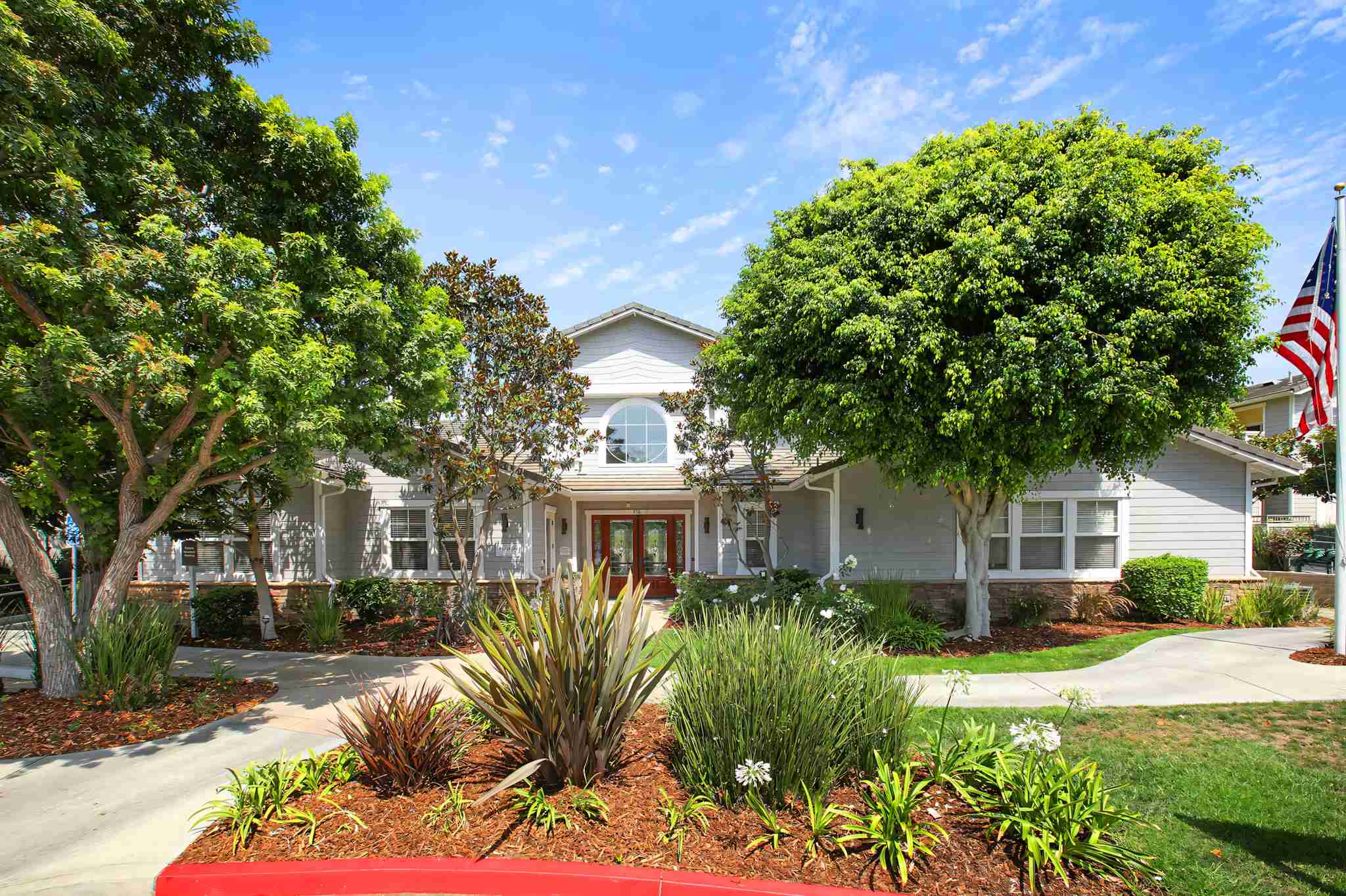 Via Ventura Apartments leasing office exterior with manicured landscaping