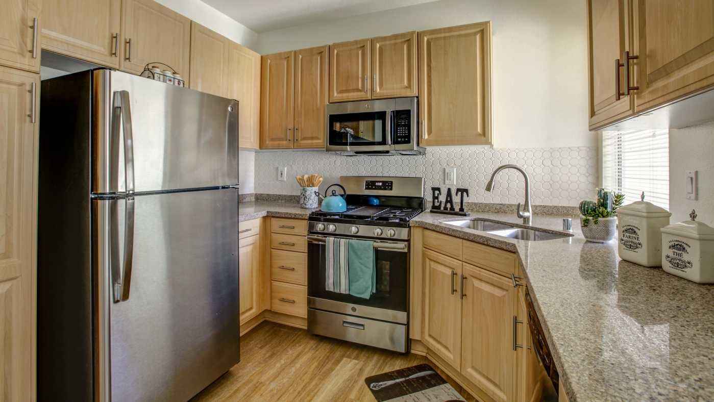renovated kitchen with granite countertops at Via Ventura