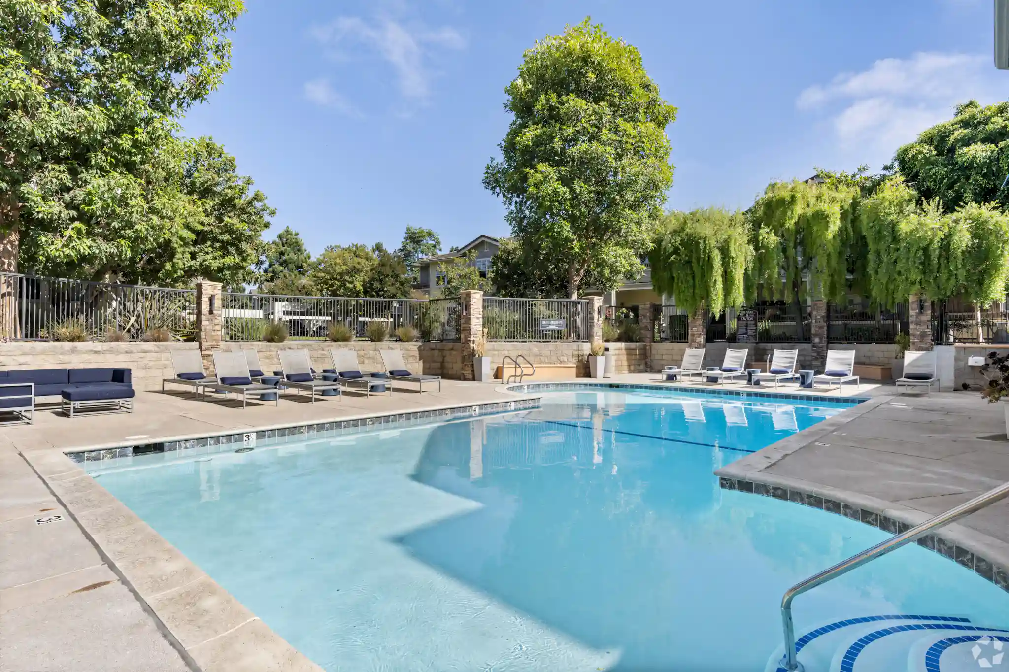 Via Ventura Apartments sparkling swimming pool with lounge chairs